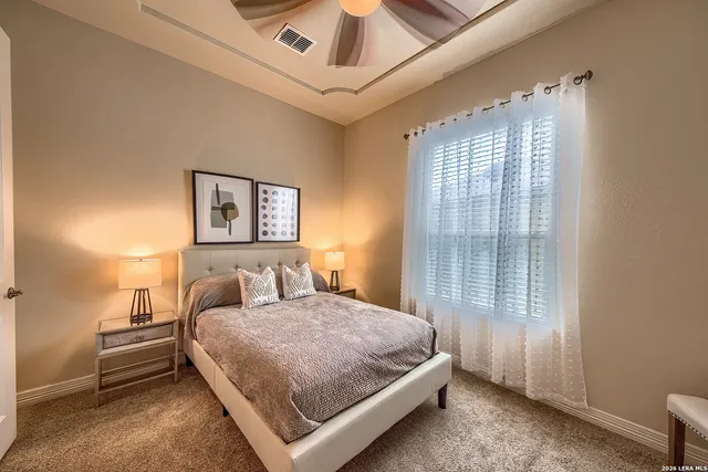 a bedroom with a bed and a large window