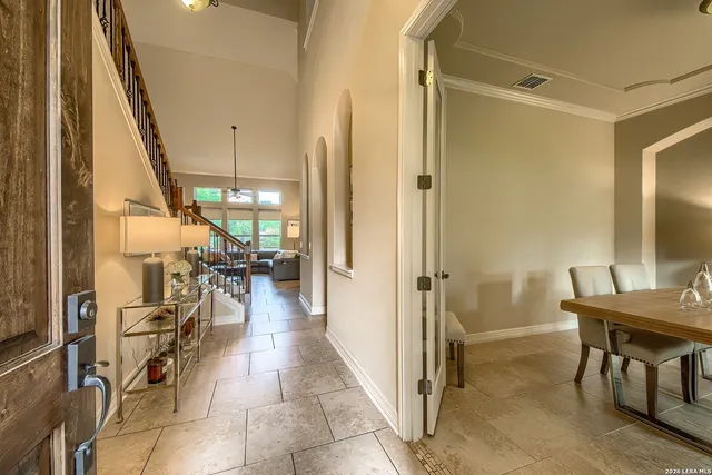 a view of a hallway with furniture and floor to ceiling window