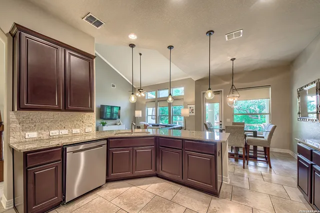 a kitchen with a sink counter top space appliances and a center island