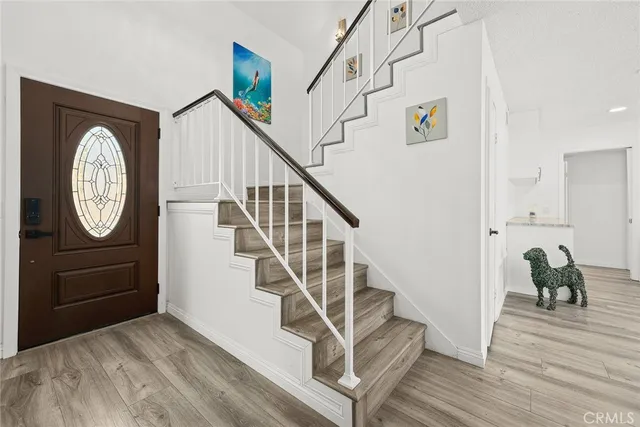 a view of entryway and hall with wooden floor