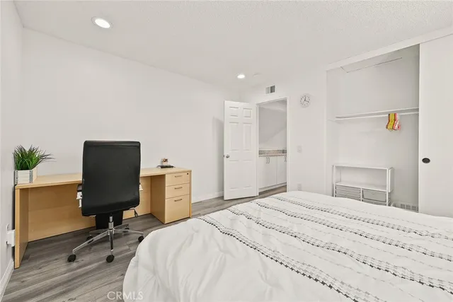 a bedroom with a bed and a chair