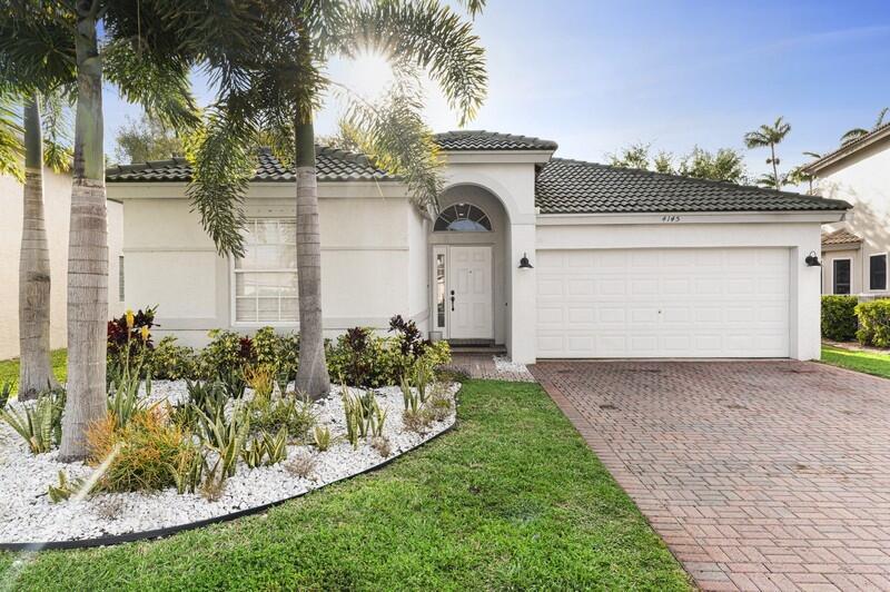 4145 Bluff Harbor Way Wellington, FL 33449 - Photo 1 of 16 a front view of a house with garden