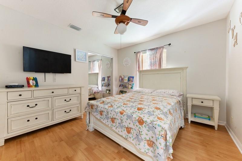 4145 Bluff Harbor Way Wellington, FL 33449 - Photo 10 of 16 a bedroom with a bed and a flat screen tv