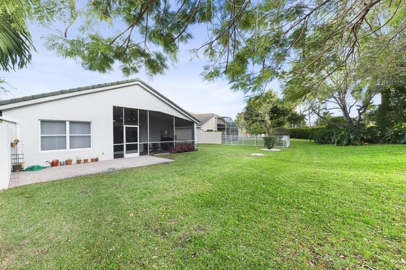 4145 Bluff Harbor Way Wellington, FL 33449 - Photo 15 of 16 a front view of house with yard and green space