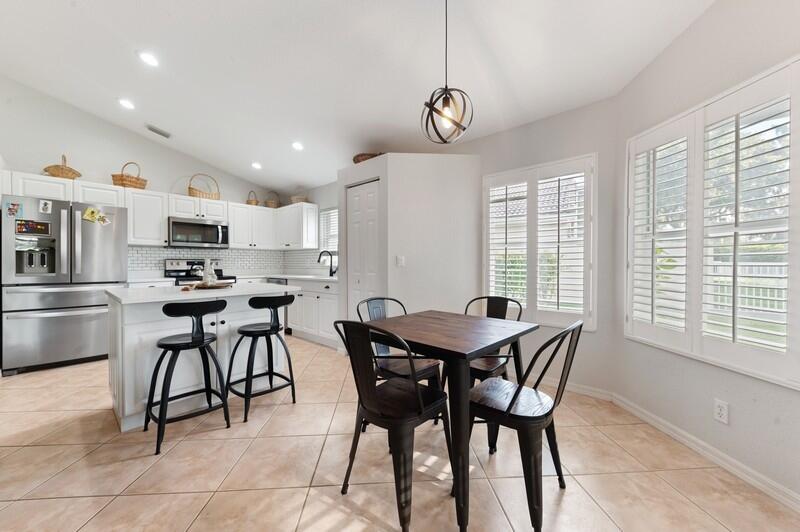 4145 Bluff Harbor Way Wellington, FL 33449 - Photo 6 of 16 a view of a dining room with furniture window and outside view