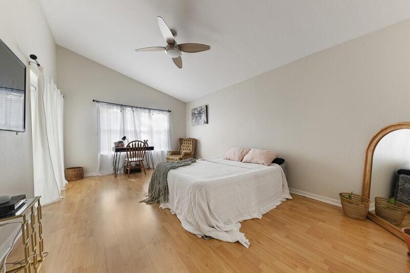 4145 Bluff Harbor Way Wellington, FL 33449 - Photo 7 of 16 a bedroom with bed and a chandelier