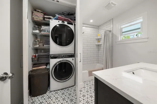 a utility room with sink dryer and washer