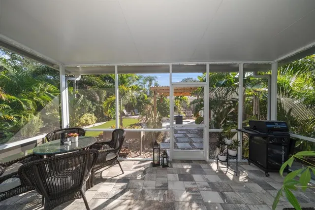 a living room with furniture and a floor to ceiling window