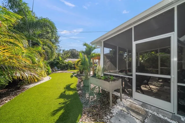 a view of a patio with table and chairs and potted plants