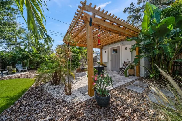 a view of a house with backyard and sitting area