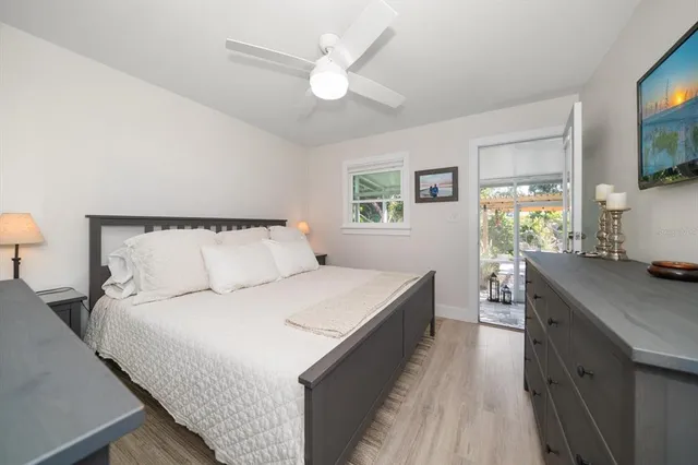 a bedroom with a large bed and a chandelier