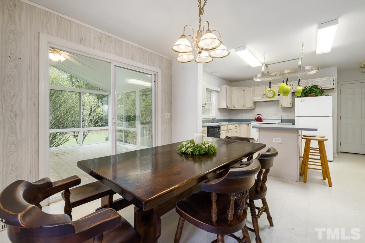200 Landmark Road Willow Spring, NC 27592 - Photo 12 of 25 a view of a dining room with furniture and a chandelier