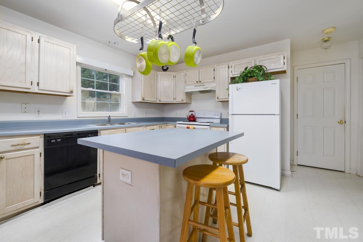 200 Landmark Road Willow Spring, NC 27592 - Photo 14 of 25 a kitchen with appliances a sink and cabinets