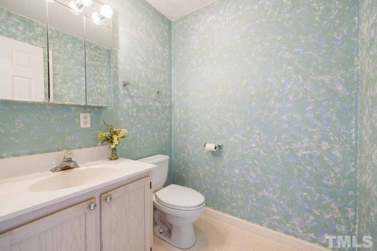 200 Landmark Road Willow Spring, NC 27592 - Photo 16 of 25 a bathroom with a sink a toilet and vanity