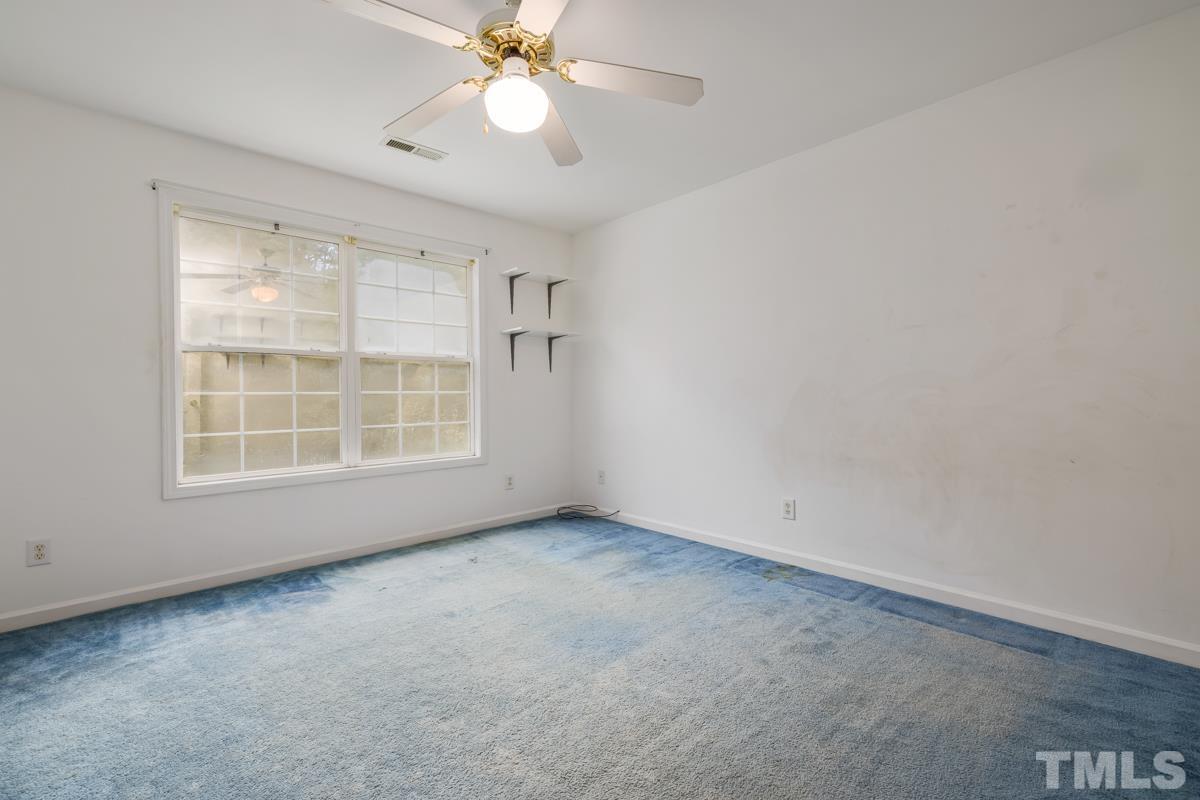 200 Landmark Road Willow Spring, NC 27592 - Photo 18 of 25 an empty room with windows and fan
