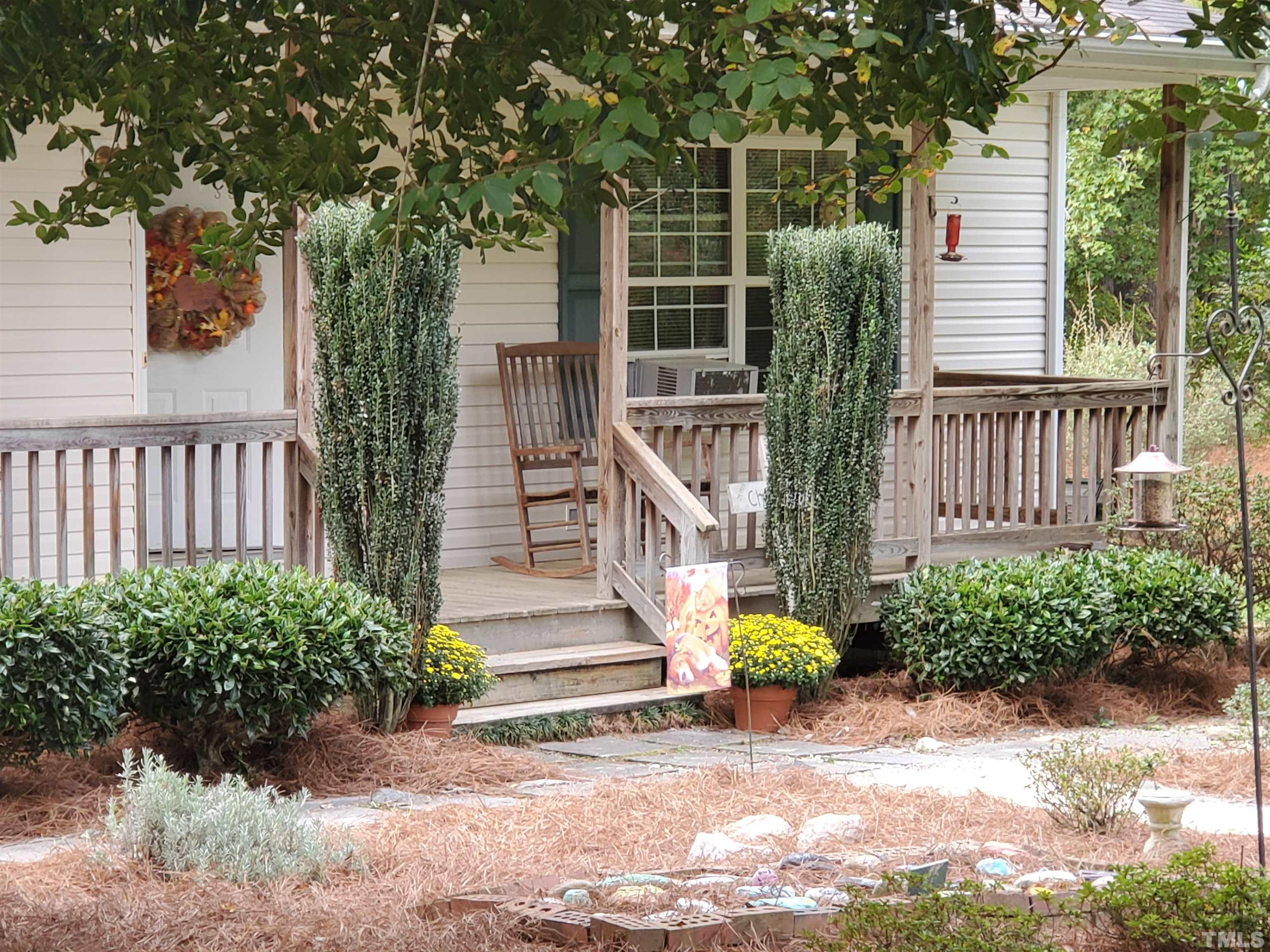 200 Landmark Road Willow Spring, NC 27592 - Photo 3 of 25 a view of small garden with plants and large trees