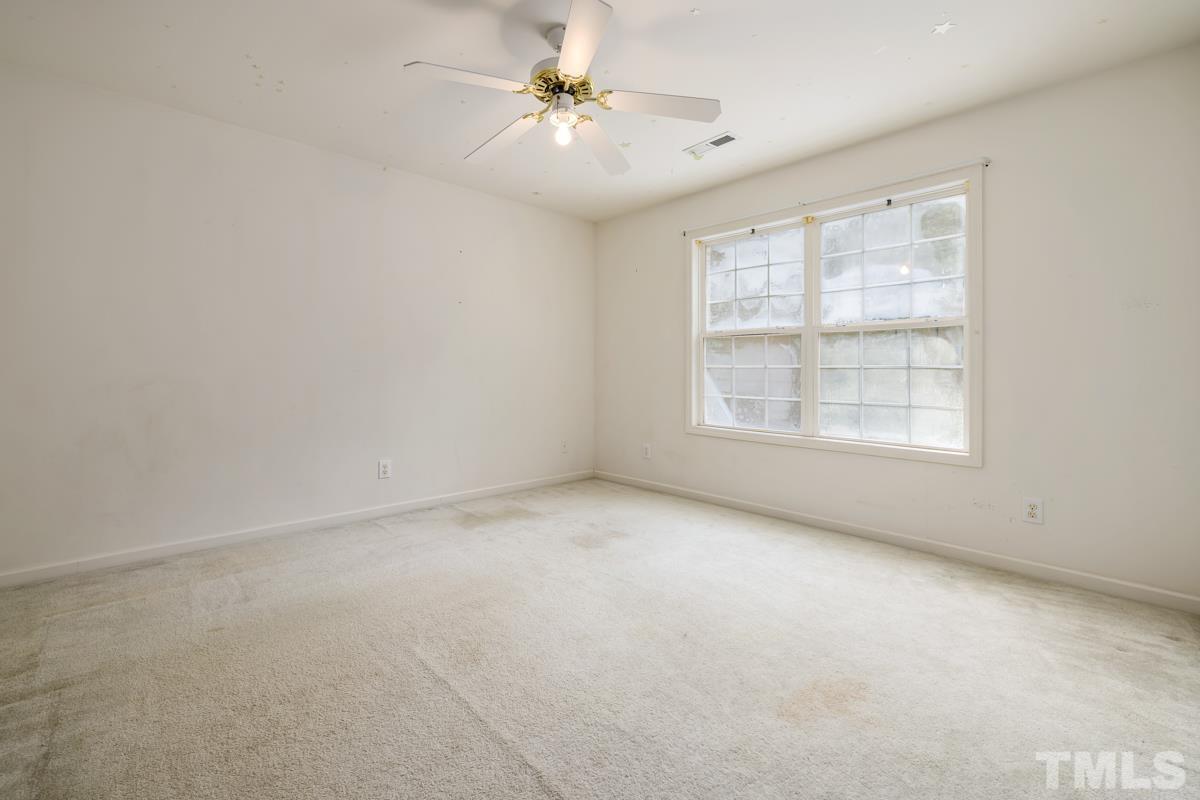 200 Landmark Road Willow Spring, NC 27592 - Photo 22 of 25 an empty room with windows and ceiling fan