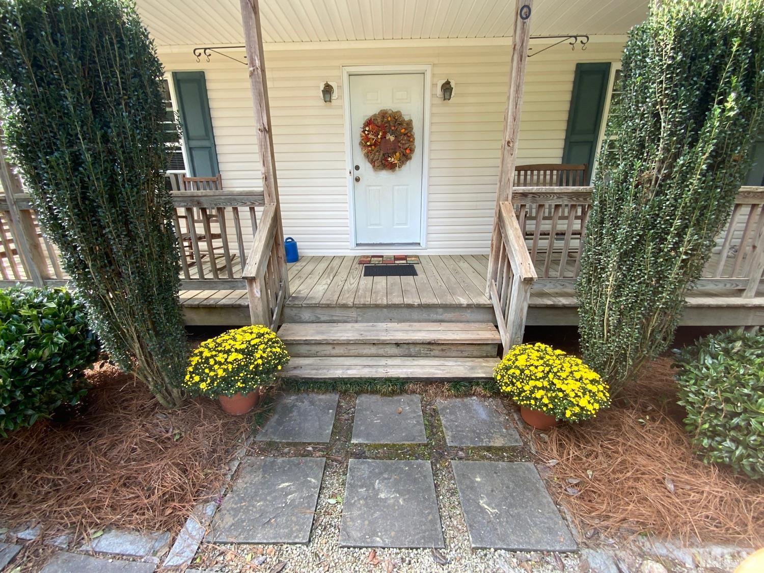 200 Landmark Road Willow Spring, NC 27592 - Photo 7 of 25 a view of a bench sitting in back yard of the house