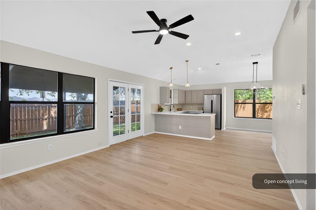 509 Brookside Court Burleson, TX 76028 - Photo 2 of 18 a view of an empty room with a window and wooden floor