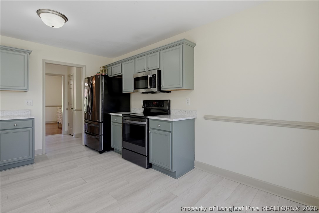 1075 Buffalo Lake Road Sanford, NC 27332 - Photo 20 of 49 a kitchen with a refrigerator stove and microwave