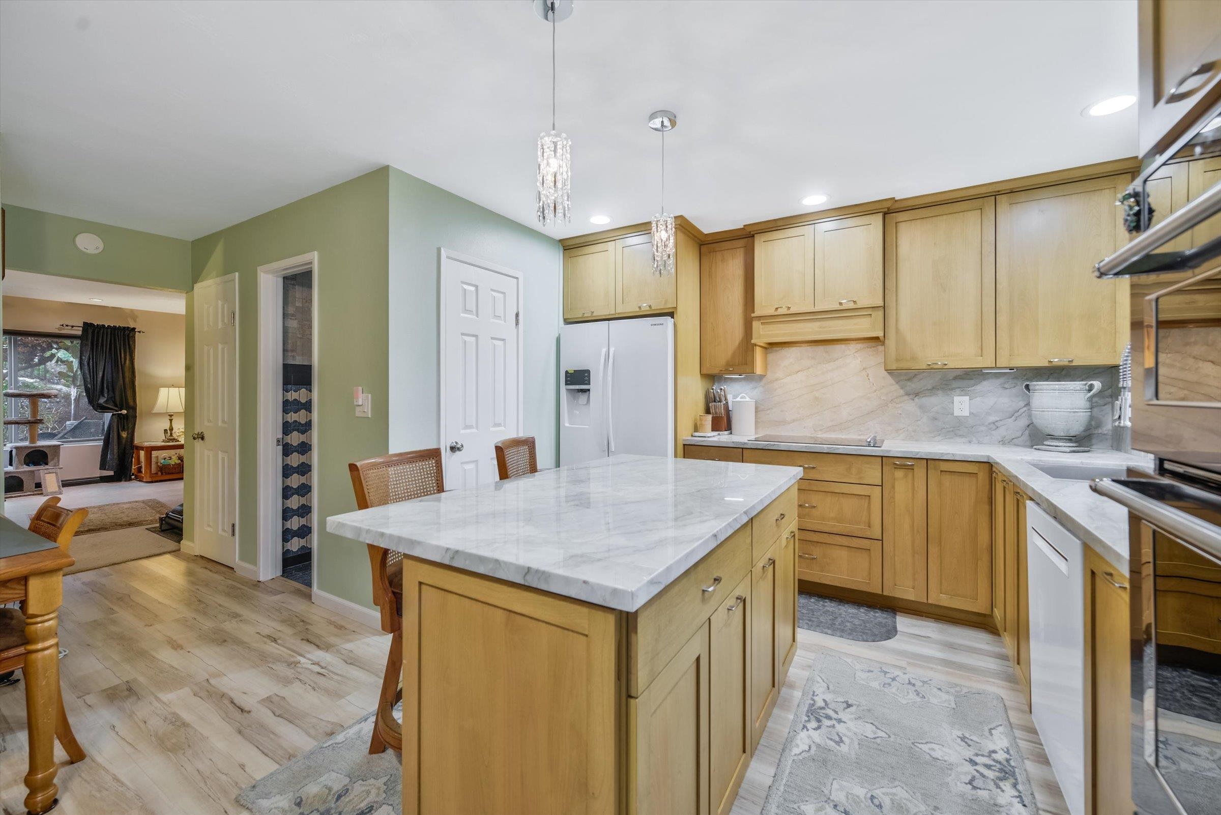 a kitchen with granite countertop a sink a counter top space and stainless steel appliances