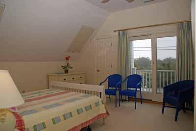 326 Morris Island Road Chatham, MA 02633 - Photo 20 of 34 a bedroom with a bed chair and a large window