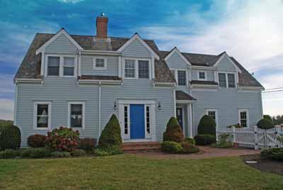 326 Morris Island Road Chatham, MA 02633 - Photo 3 of 34 a front view of a house with a garden and plants