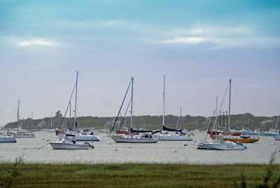 326 Morris Island Road Chatham, MA 02633 - Photo 34 of 34 a view of a lake with boats next to a bridge