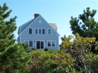 326 Morris Island Road Chatham, MA 02633 - Photo 7 of 34 a front view of a house with a yard