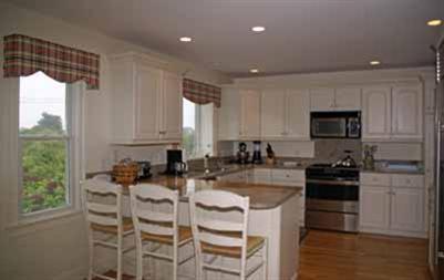 326 Morris Island Road Chatham, MA 02633 - Photo 8 of 34 a kitchen with a stove a sink and a refrigerator