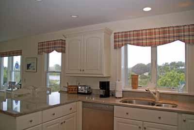326 Morris Island Road Chatham, MA 02633 - Photo 9 of 34 a kitchen with granite countertop a sink and white cabinets