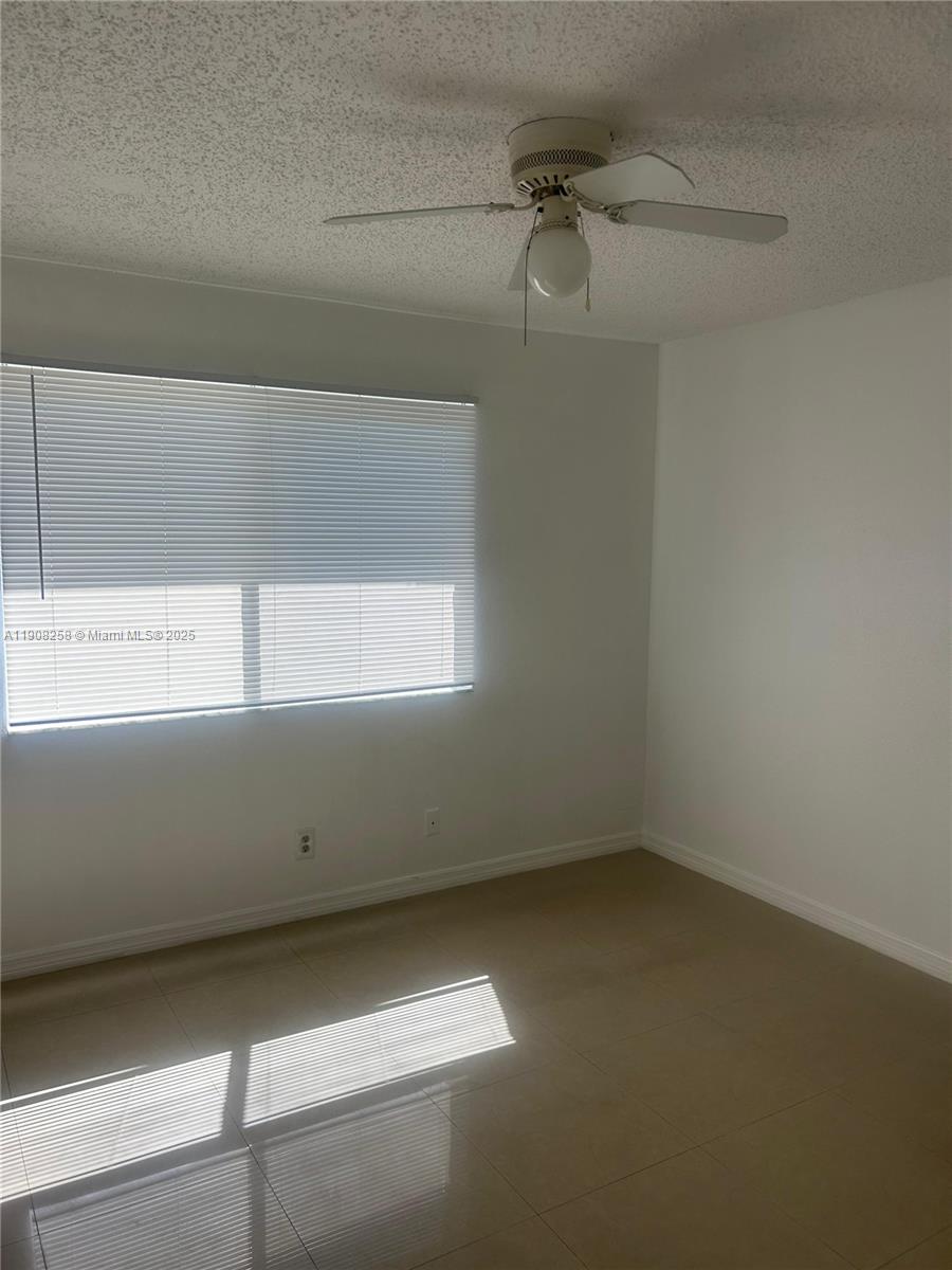 3995 West McNab Road, Unit B310 Pompano Beach, FL 33069 - Photo 4 of 10 a view of room with a window