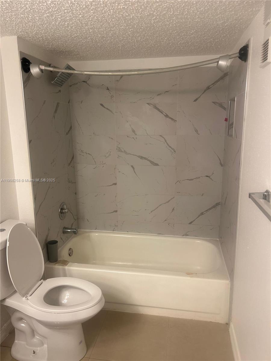 3995 West McNab Road, Unit B310 Pompano Beach, FL 33069 - Photo 6 of 10 a bathroom with a toilet and a bathtub