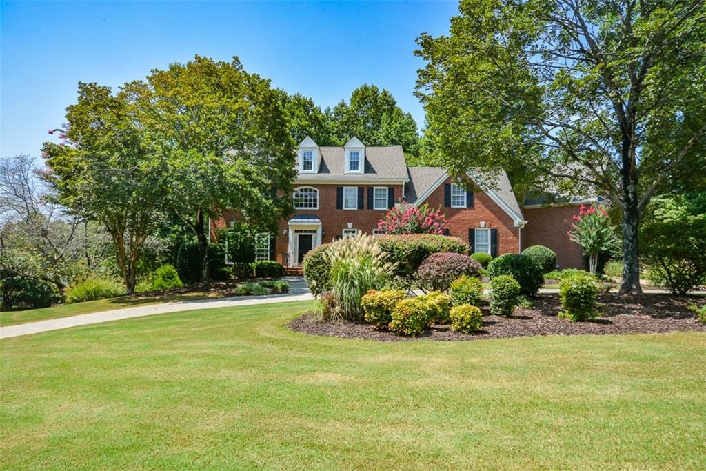 a front view of a house with a garden