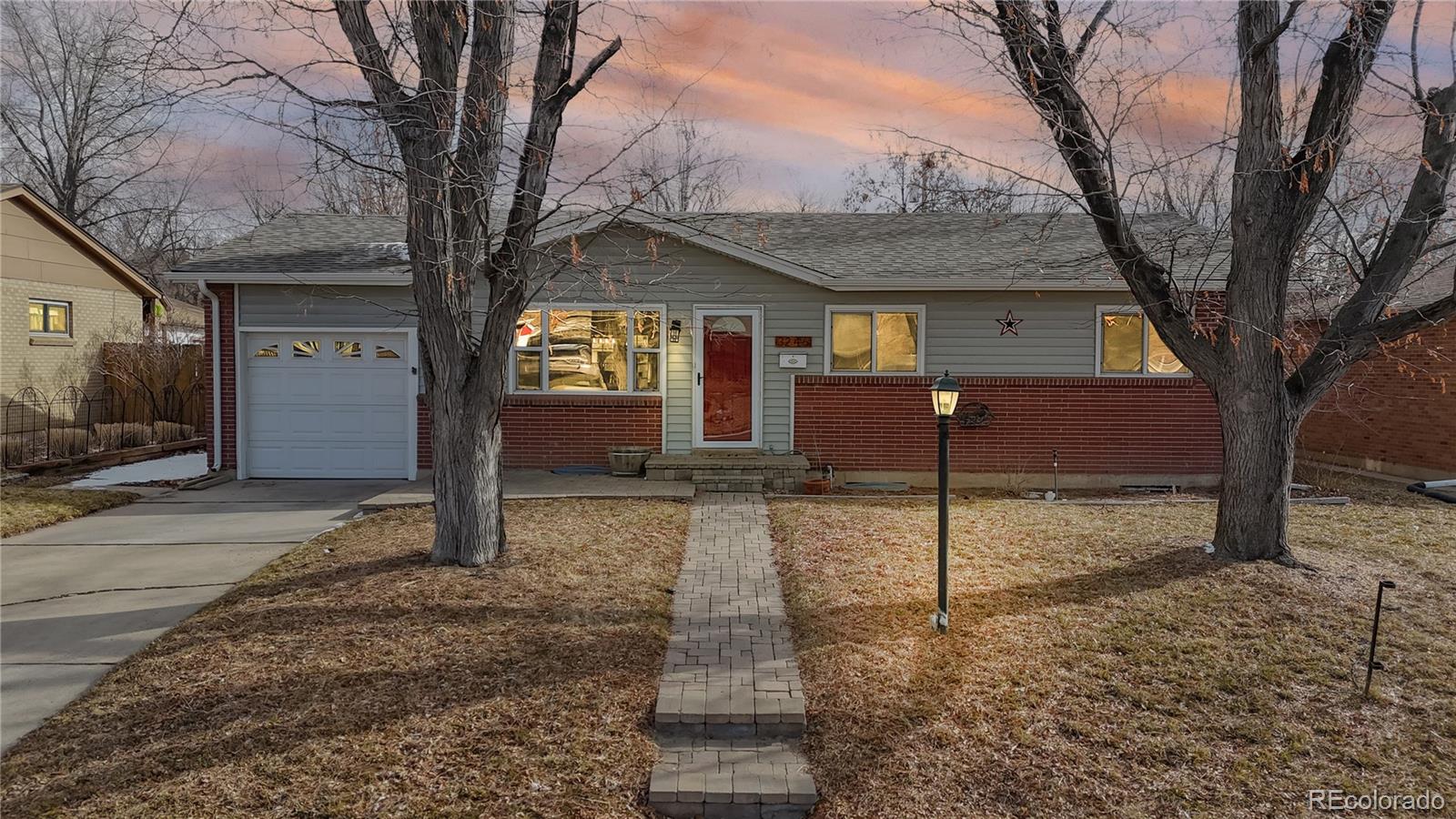 3246 South Stuart Street Denver, CO 80236 - Photo 1 of 43 a front view of a house with a yard
