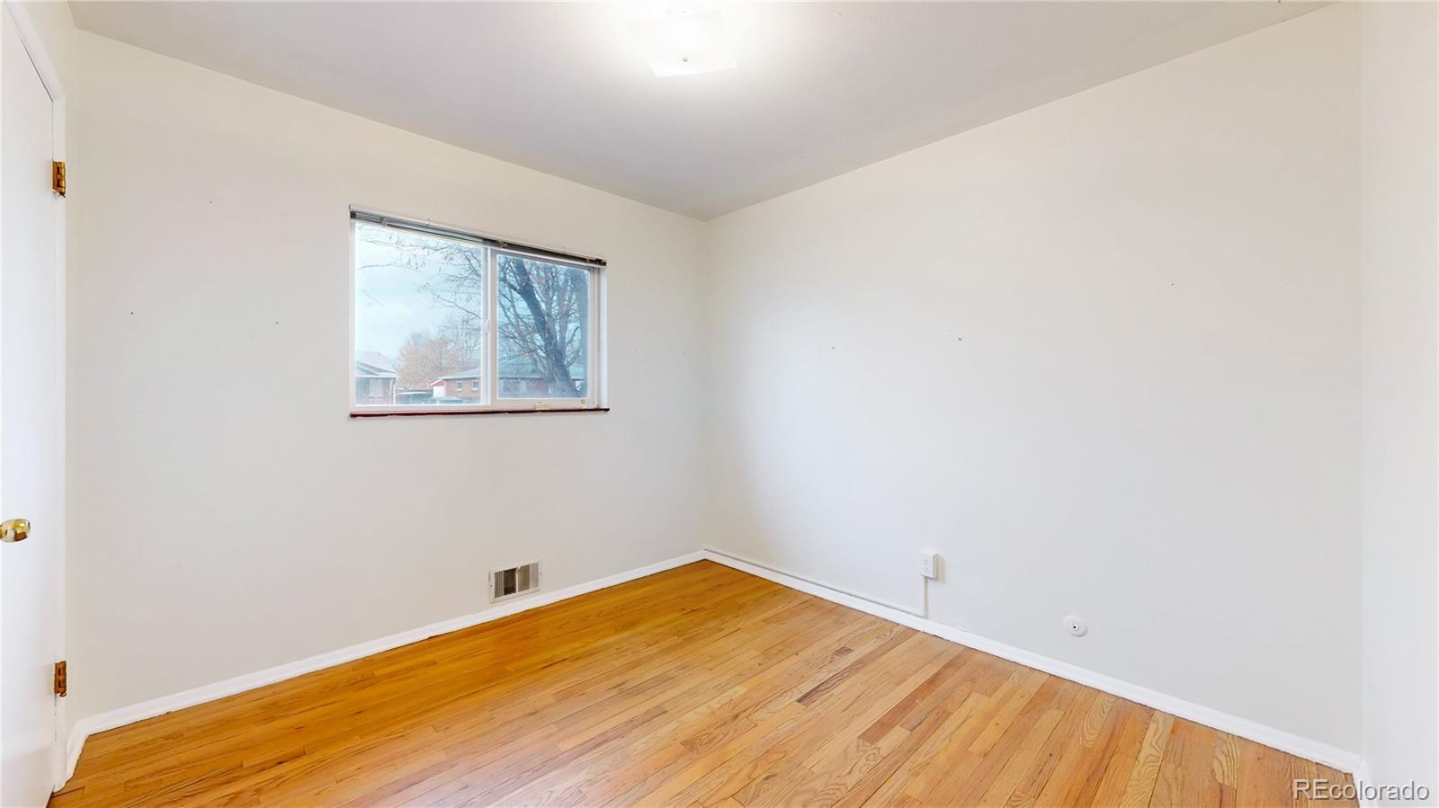 3246 South Stuart Street Denver, CO 80236 - Photo 15 of 43 a view of empty room with wooden floor