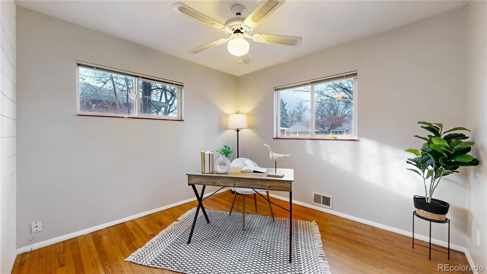 3246 South Stuart Street Denver, CO 80236 - Photo 17 of 43 a workspace with furniture and a potted plant