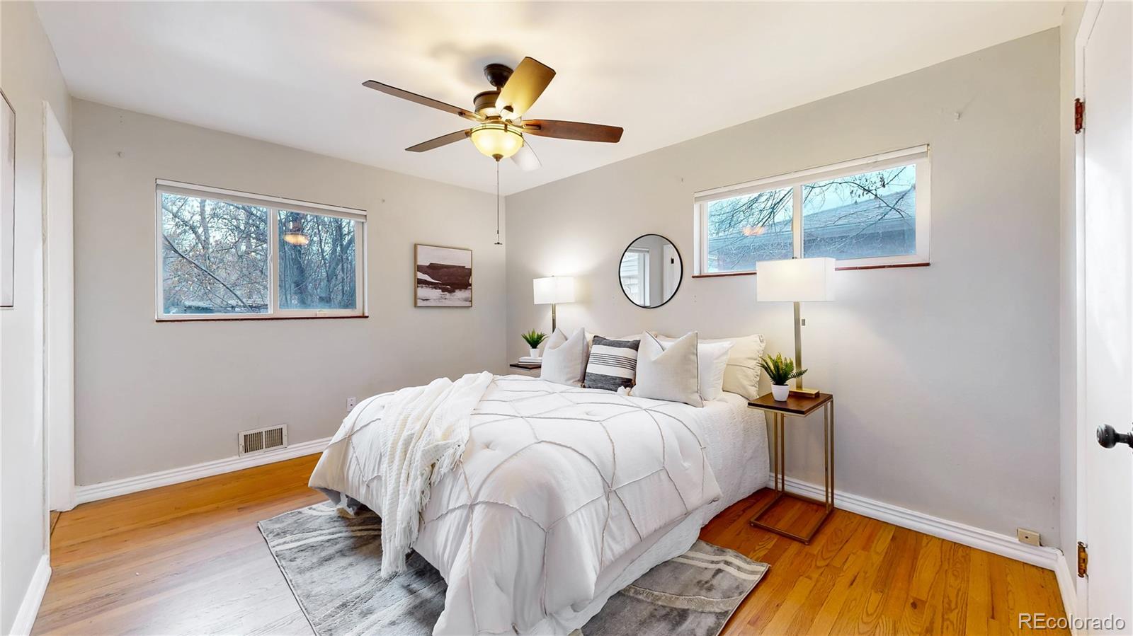 3246 South Stuart Street Denver, CO 80236 - Photo 20 of 43 a bed room with a bed and a chandelier