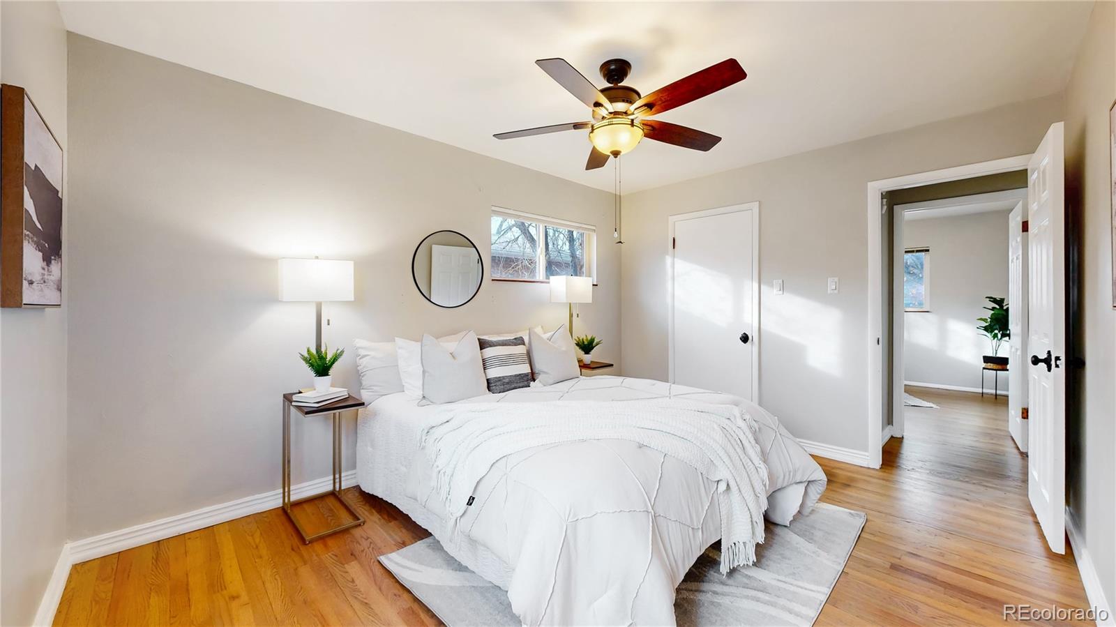 3246 South Stuart Street Denver, CO 80236 - Photo 21 of 43 a bedroom with a bed and a chandelier