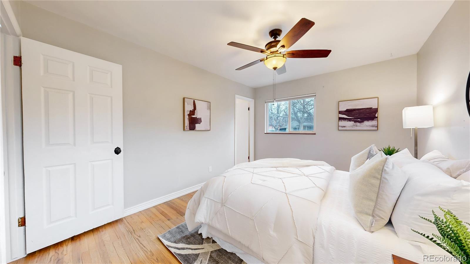 3246 South Stuart Street Denver, CO 80236 - Photo 22 of 43 a bedroom with a large bed and a window