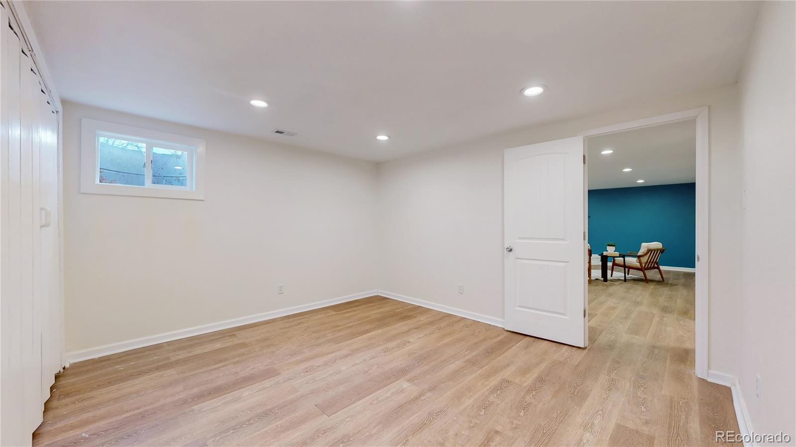 3246 South Stuart Street Denver, CO 80236 - Photo 29 of 43 a view of a living room area with furniture and wooden floor