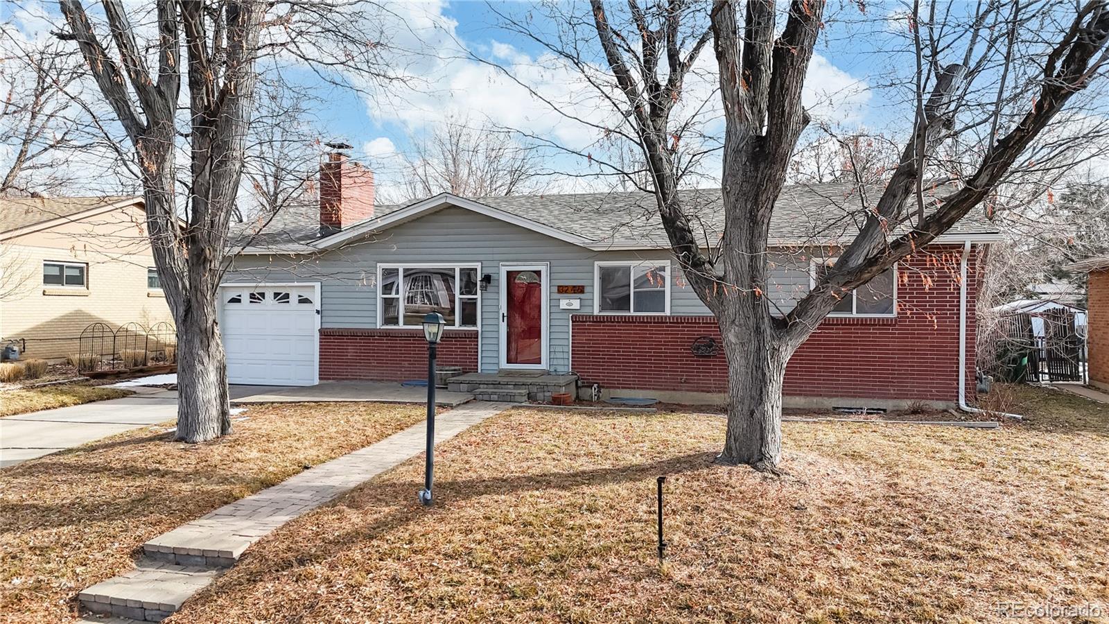 3246 South Stuart Street Denver, CO 80236 - Photo 3 of 43 a white house that has a tree in front of a house