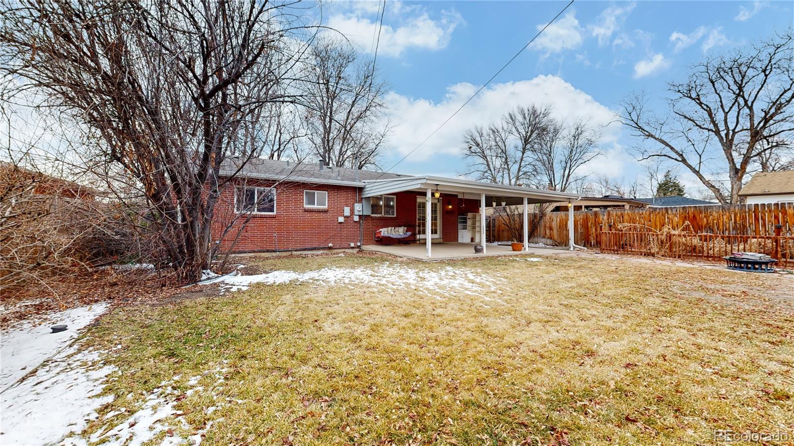 3246 South Stuart Street Denver, CO 80236 - Photo 38 of 43 a front view of a house with a yard