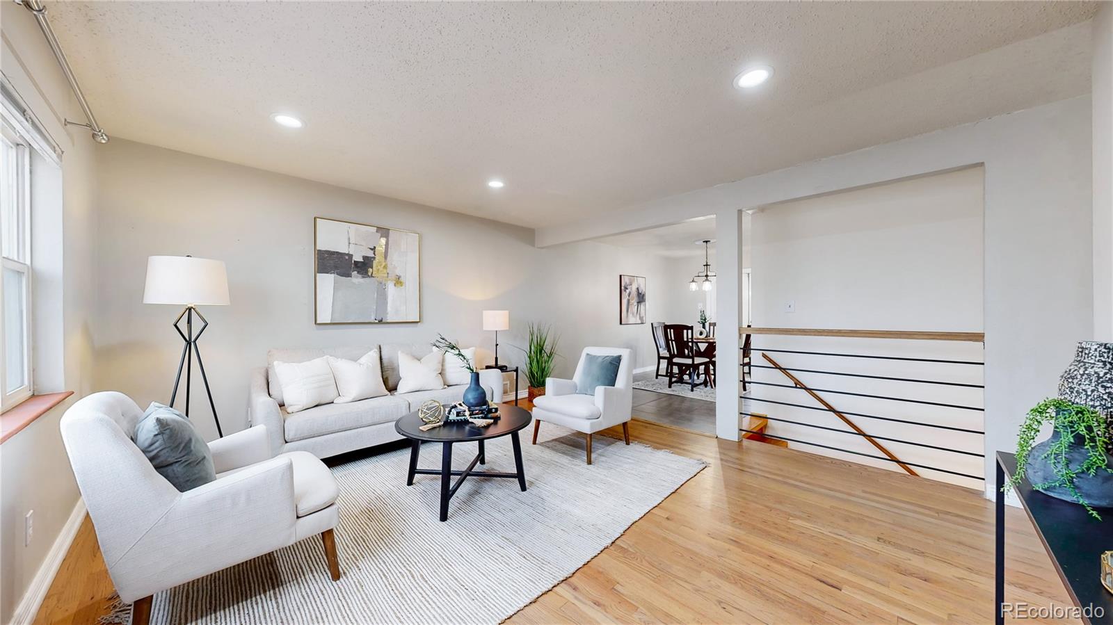 3246 South Stuart Street Denver, CO 80236 - Photo 5 of 43 a living room with furniture and wooden floor