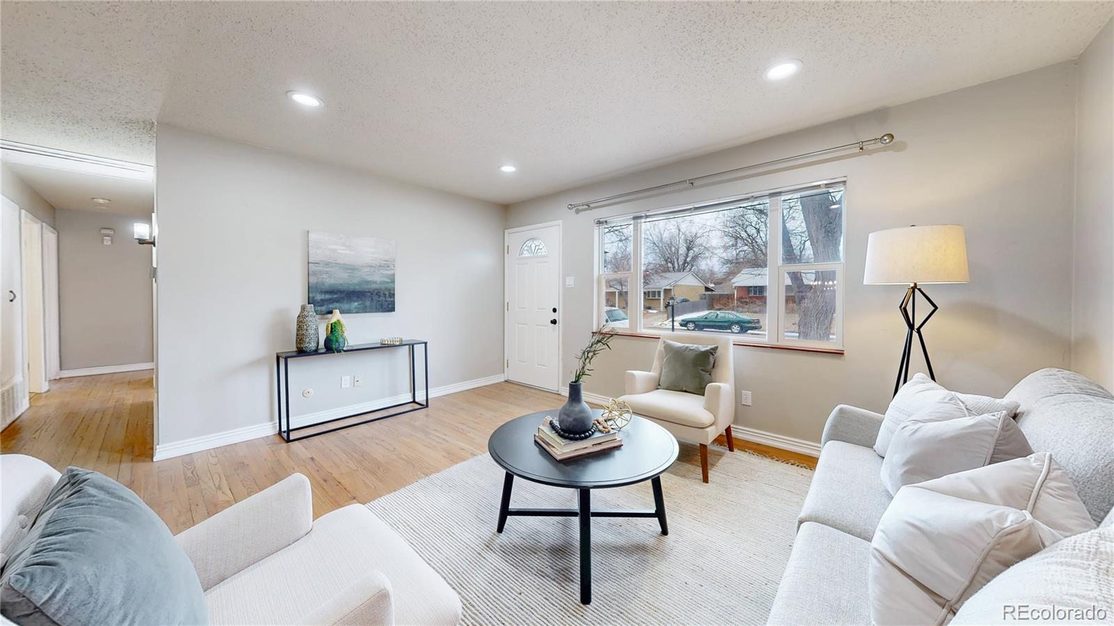 3246 South Stuart Street Denver, CO 80236 - Photo 7 of 43 a living room with furniture and a large window