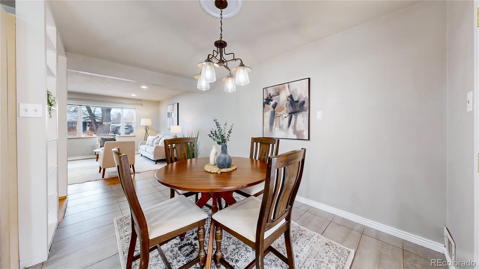 3246 South Stuart Street Denver, CO 80236 - Photo 9 of 43 a view of a dining room with furniture and wooden floor
