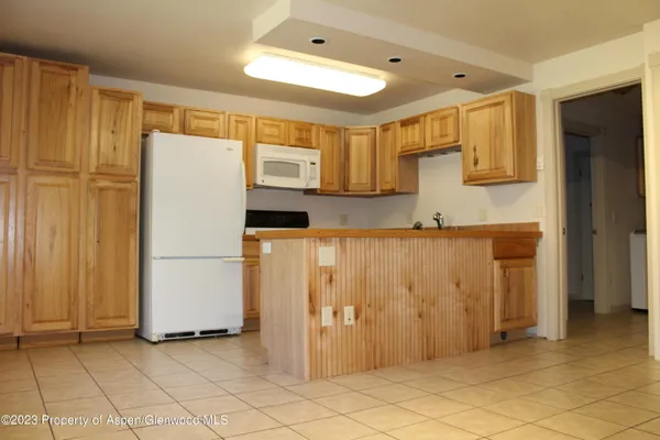 a kitchen with stainless steel appliances granite countertop a refrigerator and a stove