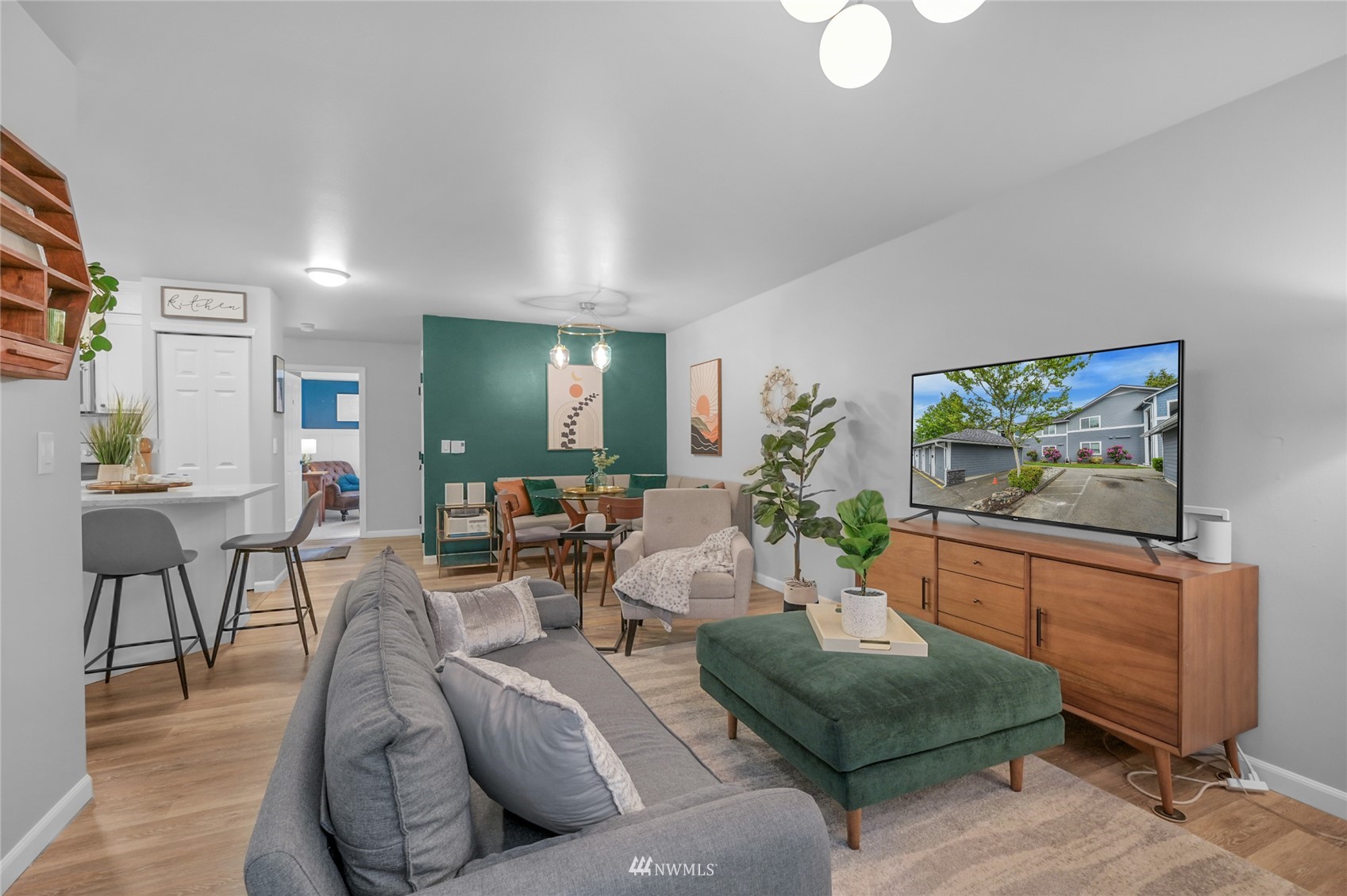 2201 192nd Street Southeast, Unit R103 Bothell, WA 98012 - Photo 11 of 29 a living room with furniture and a flat screen tv