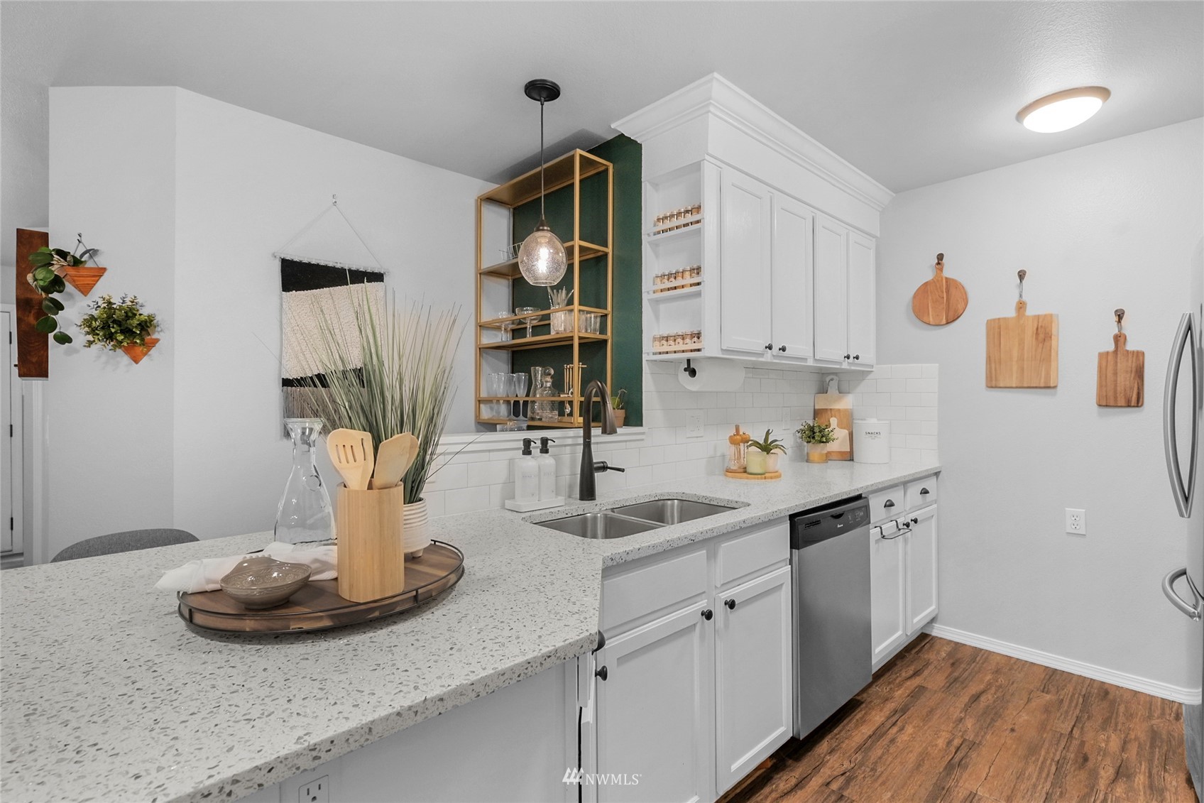 2201 192nd Street Southeast, Unit R103 Bothell, WA 98012 - Photo 5 of 29 a kitchen with a sink and a stove with wooden floor
