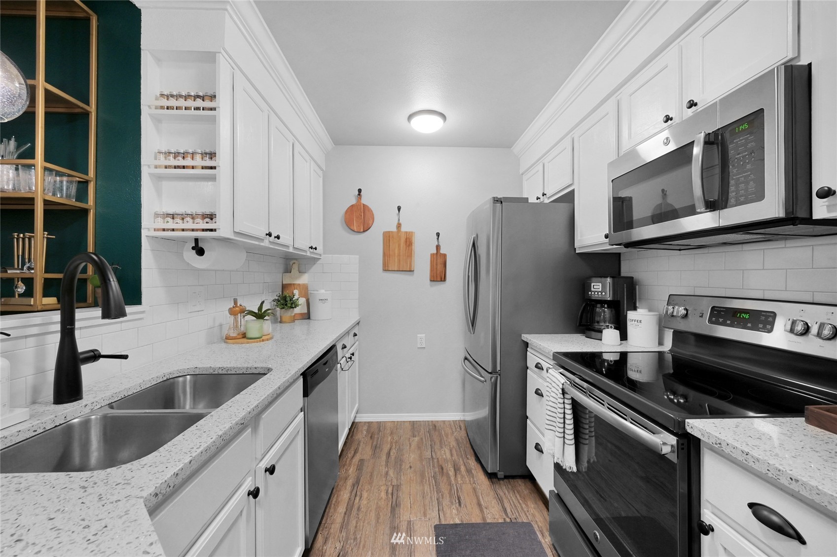 2201 192nd Street Southeast, Unit R103 Bothell, WA 98012 - Photo 6 of 29 a kitchen with stainless steel appliances granite countertop a sink stove and refrigerator